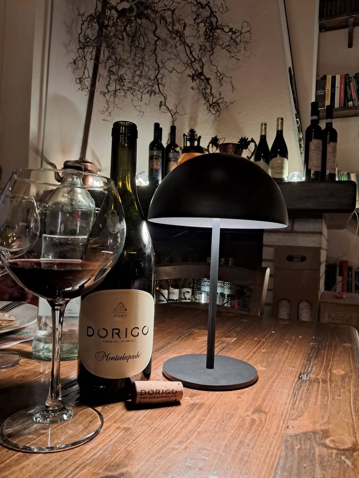 Un calice di vino sul tavolo all’interno dell’osteria